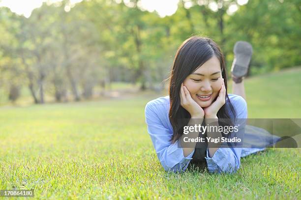 woman enjoying in nature - leaning on elbows stock pictures, royalty-free photos & images