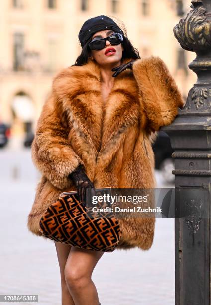 Leila Depina is seen wearing a vintage fur coat, Fendi bag, Gucci sheer gloves and a black cap with black sunglasses during the Womenswear...