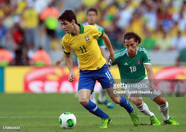 Oscar of Brazil competes with Andres Guardado of Mexico during the FIFA Confederations Cup Brazil 2013 Group A match between Brazil and Mexico at...