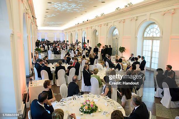 In this handout photo provided by the German Government Press Office , German Chancellor Angela Merkel makes a speech during a dinner held in honor...