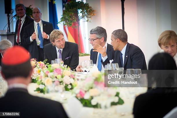 In this handout photo provided by the German Government Press Office , U.S. President Barack Obama talks with NBA basketball player Dirk Nowitzki and...