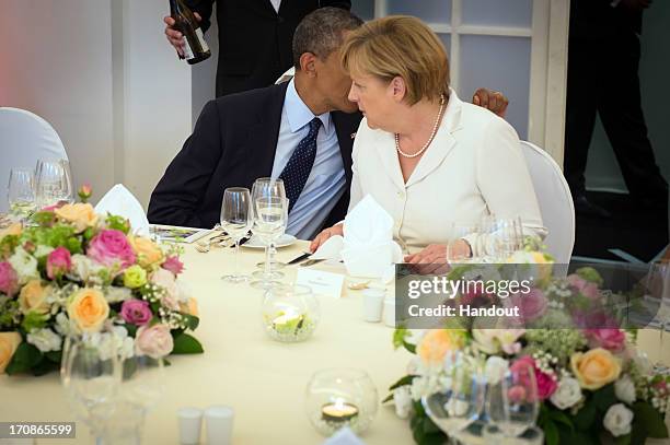 In this handout photo provided by the German Government Press Office , U.S. President Barack Obama talks with German Chancellor Angela Merkel at the...