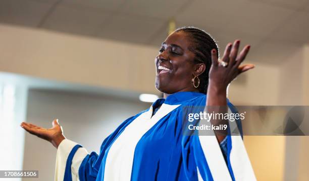 mature black woman singing in church choir - the gospel stock pictures, royalty-free photos & images