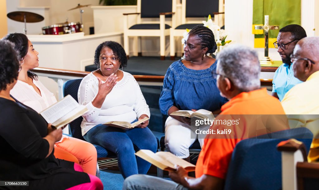 Black men and women in group bible study