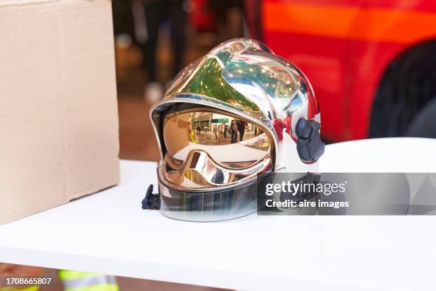 metal snow helmet in a clothing store in the foreground without people around, front view - sports merchandise stock pictures, royalty-free photos & images