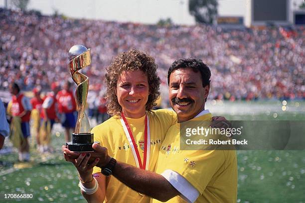 World Cup Final: Closeup of USA Michelle Akers and coach Tony DiCicco victorious with trophy after winning match vs China at Rose Bowl Stadium....