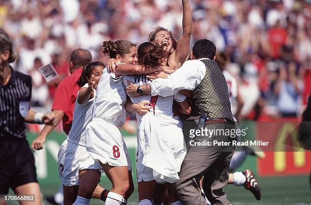 World Cup Final: USA Brandi Chastain victorious with teammates after scoring game-winning goal on penalty kick vs China at Rose Bowl Stadium....