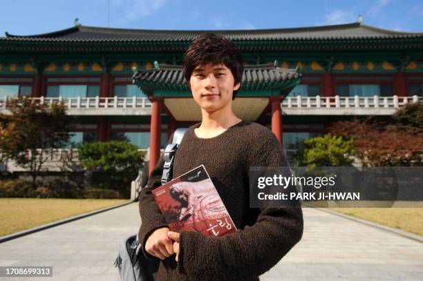 Lee Yong-Chan a Korea university student, poses for photographs at Korea University in Seoul on October 27, 2011. The world's population will surge...