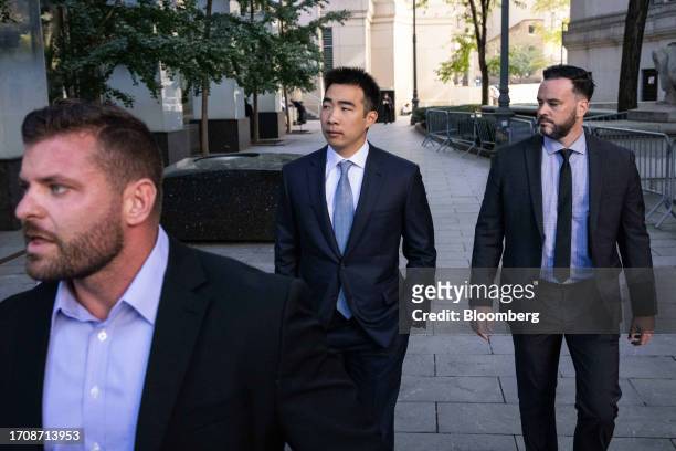 Matt Huang, co-founder and managing partner of Paradigm Operations LP, center, arrives at court in New York, US, on Thursday, Oct. 5, 2023. Former...