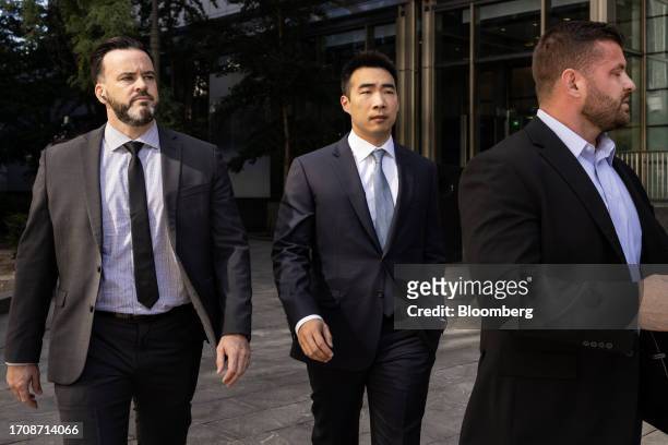 Matt Huang, co-founder and managing partner of Paradigm Operations LP, center, arrives at court in New York, US, on Thursday, Oct. 5, 2023. Former...