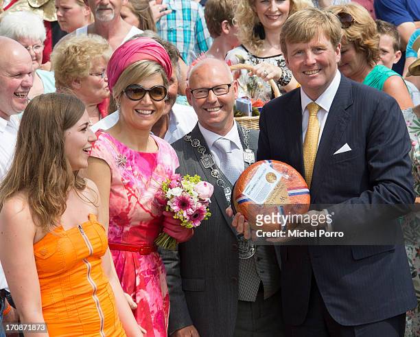 King Willem-Alexander of The Netherlands and Queen Maxima of The Netherlands receive a cheese during an official visit to the town centre on June 19,...