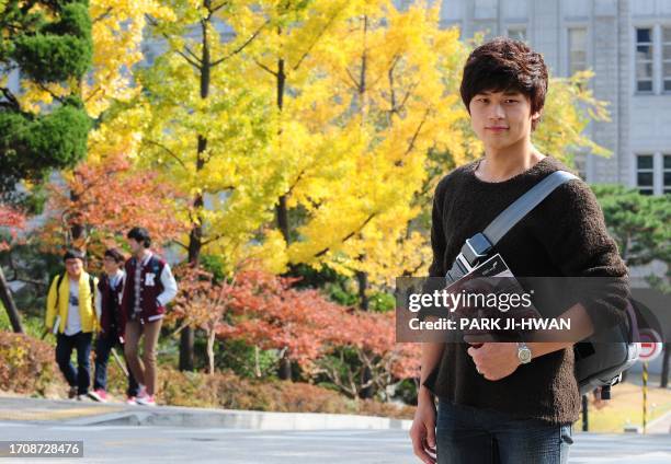 Lee Yong-Chan a Korea university student, poses in for photographs at Korea University in Seoul on October 27, 2011. The world's population will...