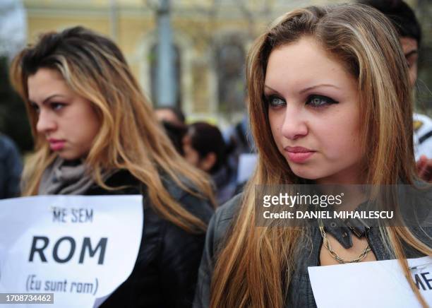 Romanian Roma comunity members wearing pancartes reading "Me sem Roma" attend a march in Bucharest on November 30, 2010. Six Roma NGO's organized a...