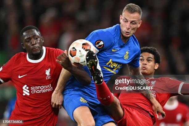 Union Saint-Gilloise's Swedish striker Gustaf Nilsson vies with Liverpool's French defender Ibrahima Konate and Liverpool's English defender Jarell...