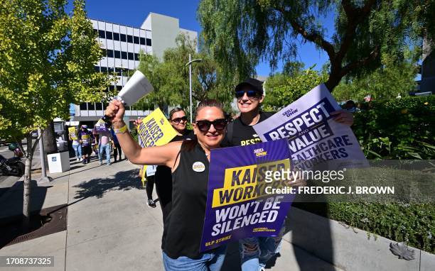 Kaiser Permanente health care employees, joind by Union members representing workers, walk the picket line in Los Angeles during the second day of...