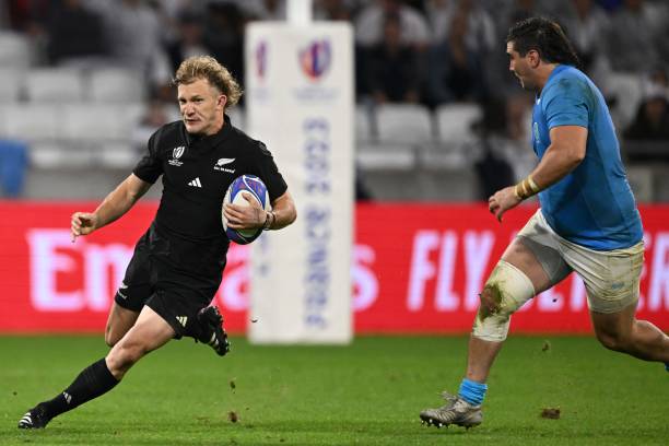 New Zealand's full-back Damian McKenzie runs with the ball during the France 2023 Rugby World Cup Pool A match between New Zealand and Uruguay at the...