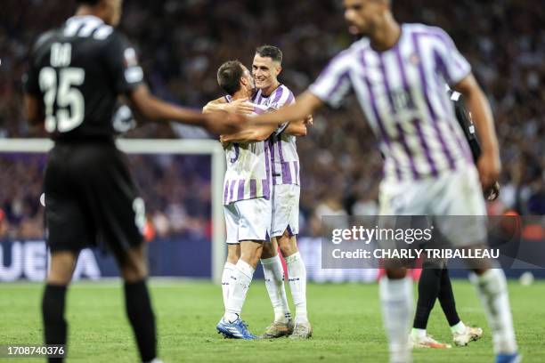 Toulouse's Australian midfielder Denis Genreau and Toulouse's Swiss midfielder Vincent Sierro celebrate at the end of the UEFA Europa League 1st...