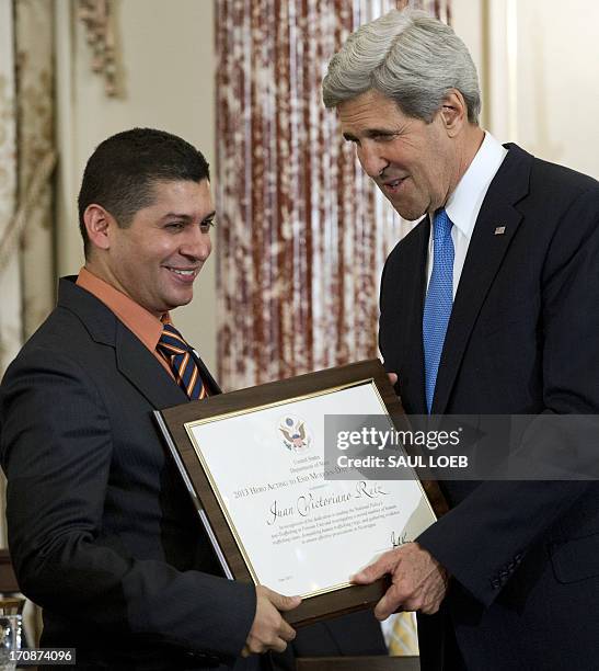 Secretary of State John Kerry presents Javier Antonio Morazan of Nicaragua with a Trafficking in Persons Heroes' award during an event releasing the...