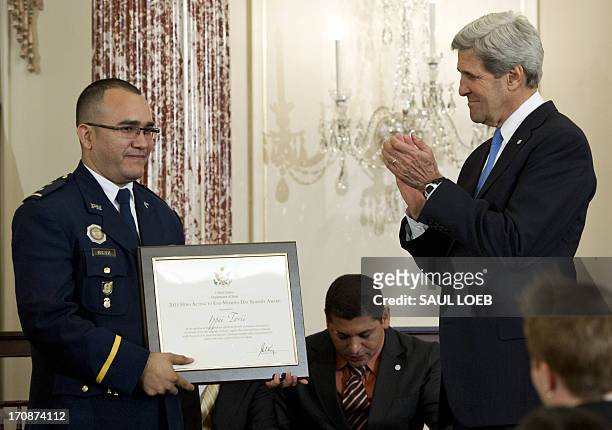 Secretary of State John Kerry presents Juan Victoriano Ruiz of Nicaragua with a Trafficking in Persons Heroes' award during an event releasing the...