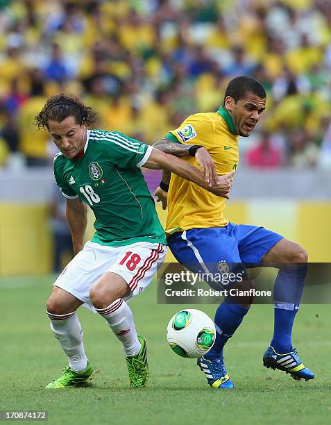 Daniel Alves of Brazil competes with Andres Guardado of Mexico during the FIFA Confederations Cup Brazil 2013 Group A match between Brazil and Mexico...