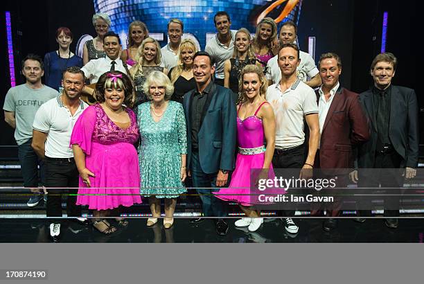 Camilla, Duchess Of Cornwall poses for a group photograph on stage with Choreographer Craig Revel Horwood and the cast after attending a performance...