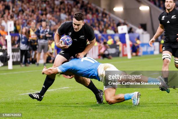 Will Jordan of New Zealand is tackled by Nicolas Freitas of Uruguay during the Rugby World Cup France 2023 match between New Zealand and Uruguay at...