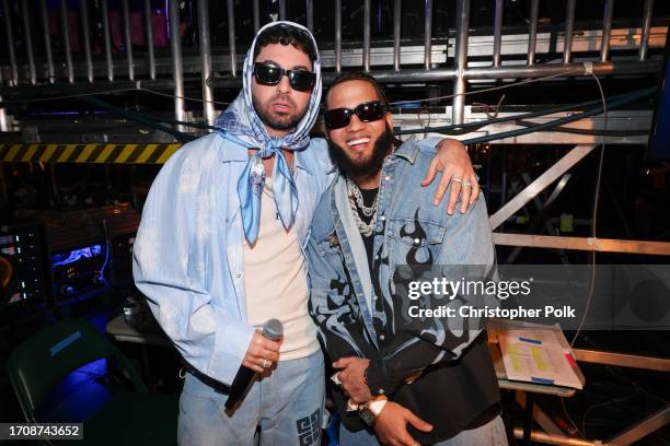 Justin Quiles and El Alfa backstage at the Billboard Latin Music Awards 2023 held at Watsco Center on October 5, 2023 in Coral Gables, Florida.