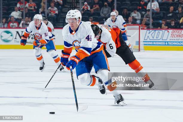 Karson Kuhlman of the New York Islanders controls the puck against the Philadelphia Flyers in the first period of the preseason game at the Wells...