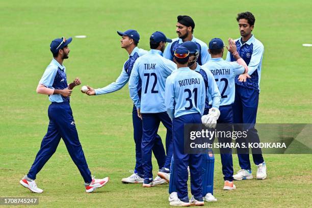 India's Ravisrinivasan Sai Kishore celebrates with teammates after the dismissal of Bangladesh's Mahmudul Joy during the 2022 Asian Games men's...