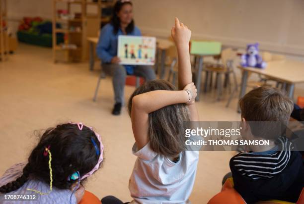 Children take part in an empathy course in a nursery school, as part of the experimentation of the application of the Danish method of combating...