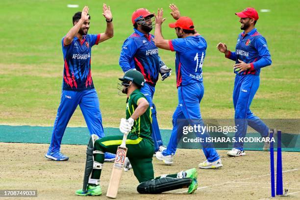 Afghanistan's Qais Ahmad celebrates with teammates after the dismissal of Pakistan's Haider Ali during the 2022 Asian Games men's second semi-final...