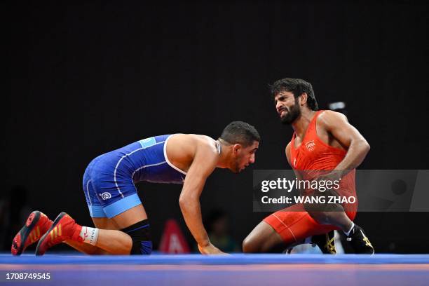 India's Bajrang reacts in the men's 65kg freestyle semi-final wrestling match against Iran's Rahman Amouzadkhalili during the 2022 Asian Games in...