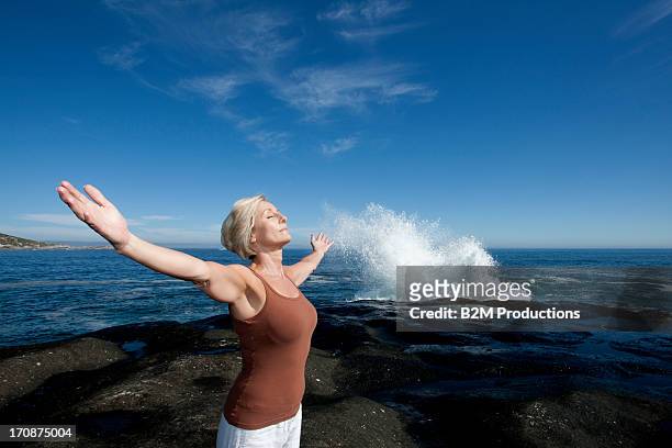 woman exercising on beach - sleeveless stock pictures, royalty-free photos & images