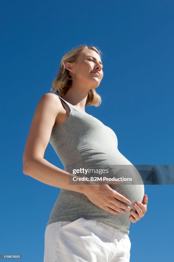 Pregnant woman holding belly