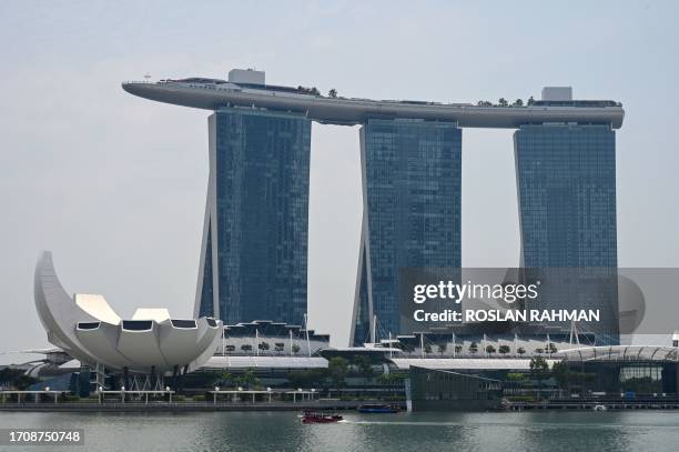 Boat passes by the Marina Bay Sands in Singapore on October 6, 2023.