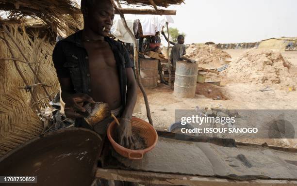 Man filters mud hoping to find gold, in Namisgma,the largest gold washing site in the country, some 200 kilometers from Ouagadougou, Northern Burkina...