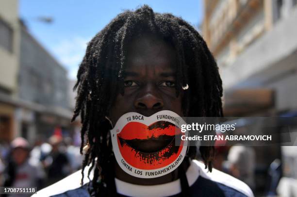 Man takes part in a march along with thousands of Latin American indigenous people, union leaders, peasant's rights organizations and youth movements...