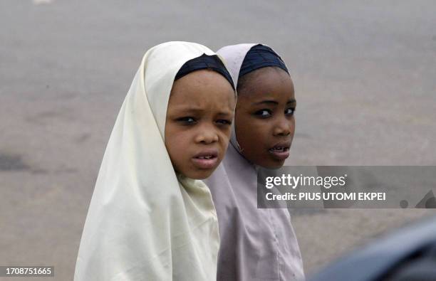 Two young Muslim girls stroll the street of Katsina town 20 April, 2007. Nigerians will tomorrow elect a president that will pilot the affairs of the...