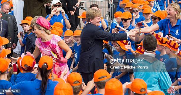 King Willem-Alexander of The Netherlands and Queen Maxima of The Netherlands make an official visit to the town centre on June 19, 2013 in Goor,...