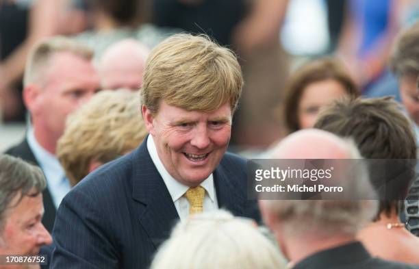 King Willem-Alexander of The Netherlands talks with people during an official visit to the town centre on June 19, 2013 in Goor, Netherlands.