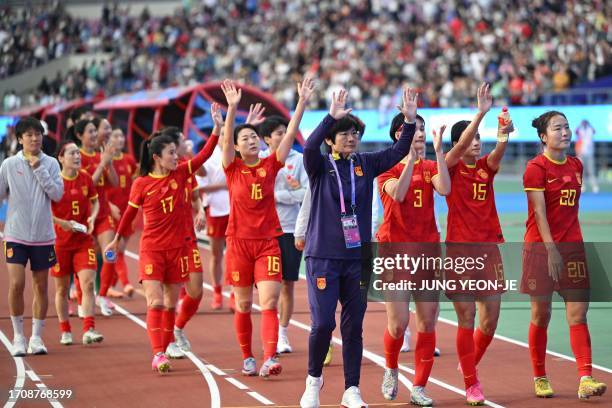 China's head coach Shui Qingxia and her players wave to fans as they celebrate their victory after the women's football bronze medal match between...