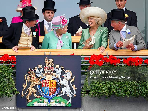 John Warren, Queen Elizabeth II, Camilla, Duchess of Cornwall and Prince Charles, Prince of Wales watch the horses in the parade ring as they attend...