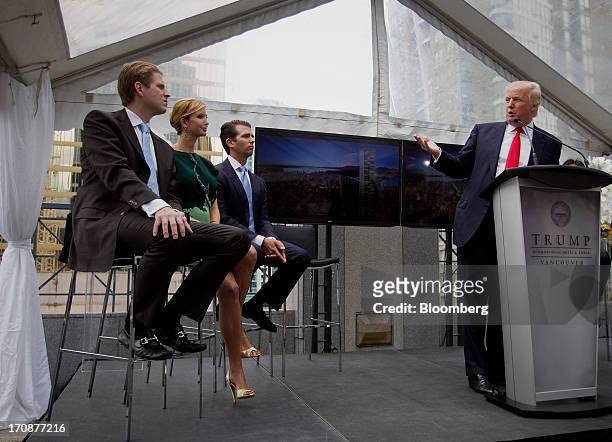 Real estate investor Donald Trump, right, speaks while his children Eric Trump, from left, Ivanka Trump and Donald Trump Jr., listen during an event...
