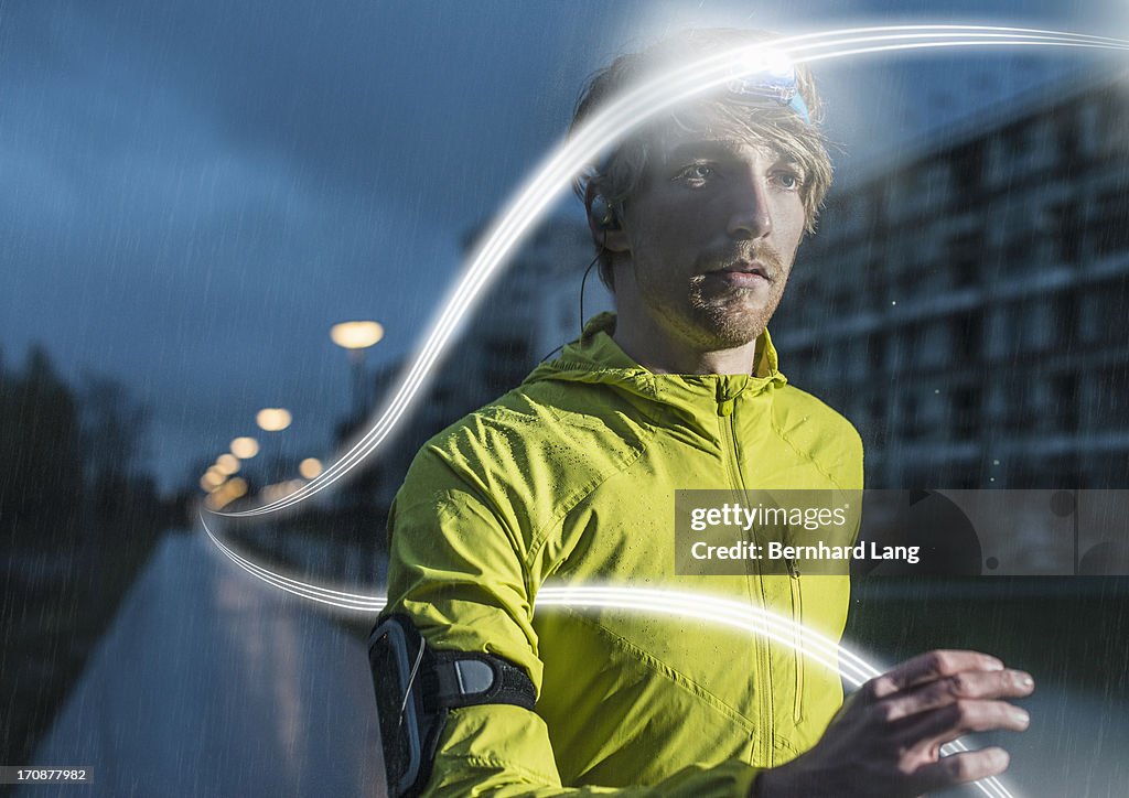 Runner surrounded by light trails in the rain