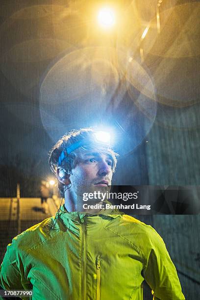 runner wearing head torch in the rain - headlamp stock pictures, royalty-free photos & images