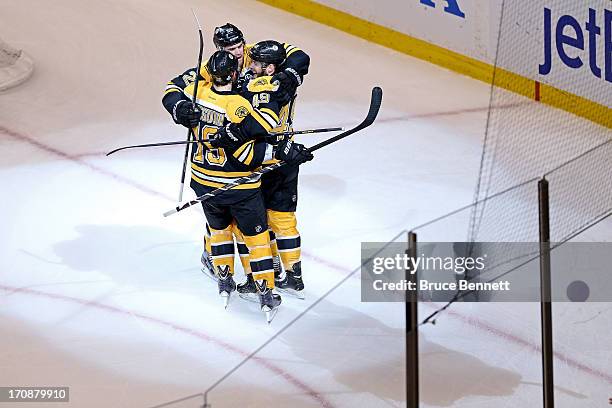 Rich Peverley of the Boston Bruins celebrates with Daniel Paille and Tyler Seguin after scoring a goal in the first period against the Chicago...