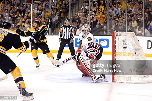 Tyler Seguin and Daniel Paille of the Boston Bruins react after a goal in the first period by Rich Peverley against Corey Crawford of the Chicago...