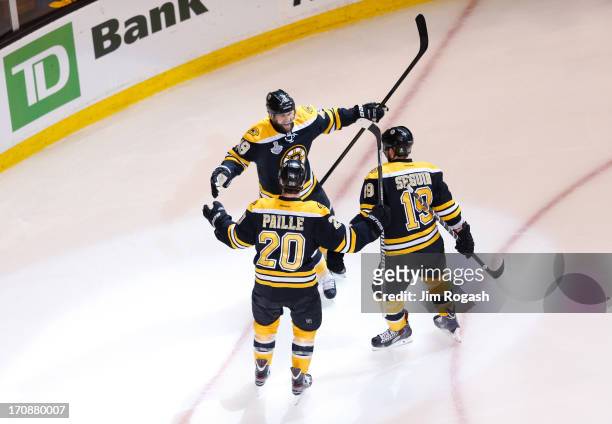 Rich Peverley of the Boston Bruins celebrates with Daniel Paille and Tyler Seguin after scoring a goal in the first period against the Chicago...