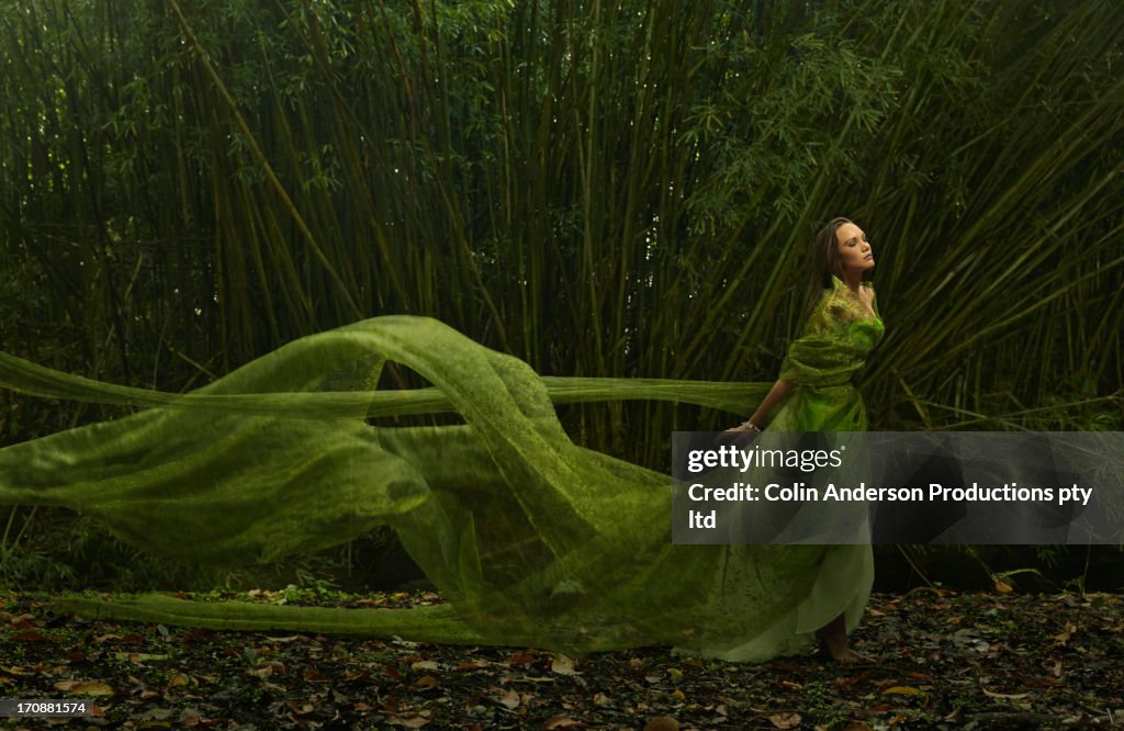Pacific Islander woman in flowing green dress outdoors