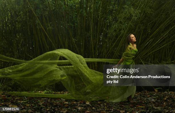 pacific islander woman in flowing green dress outdoors - evening gown fashion stock pictures, royalty-free photos & images